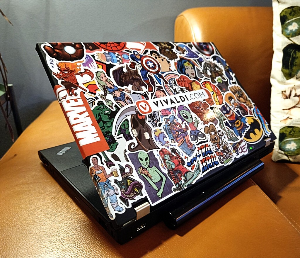 Lenovo W520 laptop with lots of stickers.
